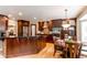 Modern kitchen with dark wood cabinetry, stainless steel appliances, and a breakfast nook at 5473 W Prentice Ct, Littleton, CO 80123