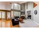 Bright and airy living room with a fireplace, hardwood floors, and floor-to-ceiling windows offering natural light at 5473 W Prentice Ct, Littleton, CO 80123