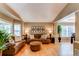 Cozy living room with plush sofas, an ottoman, and large windows offering plenty of natural light at 5473 W Prentice Ct, Littleton, CO 80123