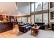 Open concept living room with large windows, dark wood accents, and comfortable seating at 5473 W Prentice Ct, Littleton, CO 80123