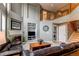 Comfortable living room featuring a fireplace, high ceilings, and a view of the upper level at 5473 W Prentice Ct, Littleton, CO 80123
