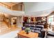 Bright and spacious living room with hardwood floors and an open layout to the kitchen at 5473 W Prentice Ct, Littleton, CO 80123