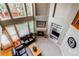 Bright living room with a fireplace, high ceilings, and plenty of natural light from the surrounding windows at 5473 W Prentice Ct, Littleton, CO 80123
