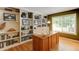 Home office featuring built-in bookshelves and a large wooden desk at 5473 W Prentice Ct, Littleton, CO 80123