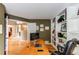 Spacious home office with a large desk and custom built-in shelving at 5473 W Prentice Ct, Littleton, CO 80123