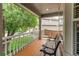Cozy covered front porch with a comfortable bench seating area at 5473 W Prentice Ct, Littleton, CO 80123
