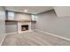 Finished basement with a cozy white painted fireplace and mantelpiece with a large world map above at 2980 S Parker Ct, Aurora, CO 80014