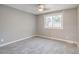 Bedroom with neutral gray walls, carpet flooring and large window with view of the backyard at 2980 S Parker Ct, Aurora, CO 80014