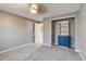 Bedroom with carpet flooring, gray walls, and open closet with shelving and drawers at 2980 S Parker Ct, Aurora, CO 80014