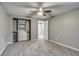 Neutral bedroom featuring gray walls, a ceiling fan, a closet with shelving, and neutral carpeting at 2980 S Parker Ct, Aurora, CO 80014