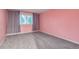 A bedroom with pink walls, carpet flooring, a window, and light-blocking curtains at 2980 S Parker Ct, Aurora, CO 80014