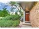 Inviting front entrance with a wooden door and beautiful brick accents at 2980 S Parker Ct, Aurora, CO 80014