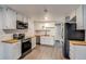Bright kitchen with stainless appliances, butcher block counters and wood floors at 2980 S Parker Ct, Aurora, CO 80014
