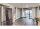 Inviting living area featuring a refrigerator, sliding glass doors, and wood-look floors at 2980 S Parker Ct, Aurora, CO 80014