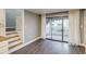 Bright living room featuring gray walls, hardwood floors, sliding glass doors, and easy access to the backyard patio at 2980 S Parker Ct, Aurora, CO 80014