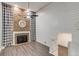 A living room featuring a brick fireplace, luxury vinyl plank floors, and stairs to the basement at 2980 S Parker Ct, Aurora, CO 80014