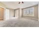 This bedroom has carpet, a door to a patio, and a large window with shutters for great natural light at 10311 Belvedere Ln, Lone Tree, CO 80124