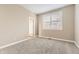 This bedroom has carpet and a window with lovely shutters for great natural light at 10311 Belvedere Ln, Lone Tree, CO 80124