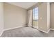 Neutral bedroom with carpet, natural light from patio window, and an en suite door at 10311 Belvedere Ln, Lone Tree, CO 80124