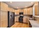 Galley kitchen featuring light wood cabinets, stainless appliances, and hardwood floors at 10311 Belvedere Ln, Lone Tree, CO 80124