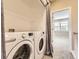 The modern laundry room offers a large washer and dryer at 10311 Belvedere Ln, Lone Tree, CO 80124