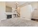 Bright living room with high ceilings, carpet, and a fireplace with a stone surround at 10311 Belvedere Ln, Lone Tree, CO 80124
