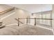 Open loft area featuring neutral carpet, white railings, and a chandelier at 10311 Belvedere Ln, Lone Tree, CO 80124
