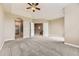 Spacious main bedroom with tray ceiling, carpeted floors, walk-in closet, and ensuite bathroom access at 10311 Belvedere Ln, Lone Tree, CO 80124