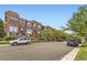 Charming street featuring brick townhomes, manicured landscaping, and tree-lined sidewalks at 10311 Belvedere Ln, Lone Tree, CO 80124