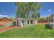 Well-maintained backyard with lush green grass, mulch, and a versatile storage shed at 8361 Mason Cir, Westminster, CO 80031