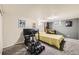 Basement recreational area with gray carpet, simulator equipment, and a pinball machine at 8361 Mason Cir, Westminster, CO 80031