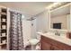 Bathroom with a white shower and vanity with wood toned drawers at 8361 Mason Cir, Westminster, CO 80031