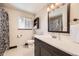Bright bathroom with a black and white shower curtain and dark brown vanity at 8361 Mason Cir, Westminster, CO 80031