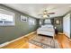Comfortable bedroom with wood floors, a ceiling fan, and natural lighting at 8361 Mason Cir, Westminster, CO 80031