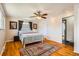 Cozy bedroom showcases hardwood floors, a ceiling fan, and comfortable furnishings at 8361 Mason Cir, Westminster, CO 80031