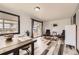 Inviting dining area with natural light, modern furnishings, and wood-look floors at 8361 Mason Cir, Westminster, CO 80031