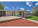Back exterior view showing garage, patio, and backyard with lush green grass and mulch at 8361 Mason Cir, Westminster, CO 80031