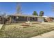 Attractive brick home with a well-maintained lawn, a lovely walkway, and mature trees at 8361 Mason Cir, Westminster, CO 80031