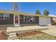 Charming brick home with a well-manicured lawn, a front porch, and a one car garage at 8361 Mason Cir, Westminster, CO 80031