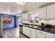Kitchen featuring stainless steel appliances, white cabinets, and black countertops at 8361 Mason Cir, Westminster, CO 80031