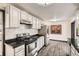 Kitchen with stainless steel appliances, white subway tile backsplash, and white cabinets at 8361 Mason Cir, Westminster, CO 80031