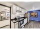 Modern kitchen with white cabinets, stainless steel appliances, and open layout at 8361 Mason Cir, Westminster, CO 80031
