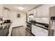 Well-maintained kitchen featuring white cabinets, black countertops, and stainless steel appliances at 8361 Mason Cir, Westminster, CO 80031