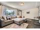 Comfortable living room with a large window, plush sectional sofa, and neutral decor at 8361 Mason Cir, Westminster, CO 80031