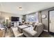 Inviting living room with a large sectional, entertainment center, and natural light at 8361 Mason Cir, Westminster, CO 80031