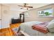 Bright bedroom with hardwood floors, multiple windows, and a cozy rug for a comfortable atmosphere at 8361 Mason Cir, Westminster, CO 80031