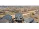 Aerial view showcases the gray roof, two-car garage, and green lawn at 19060 E 54Th Pl, Denver, CO 80249