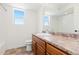 Bathroom featuring a sink, toilet, and shower with natural light from the window at 19060 E 54Th Pl, Denver, CO 80249