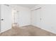 Bright bedroom featuring neutral carpeting and a hallway with an open door at 19060 E 54Th Pl, Denver, CO 80249