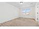 A simply designed bedroom with neutral-colored walls and carpet, with large windows at 19060 E 54Th Pl, Denver, CO 80249
